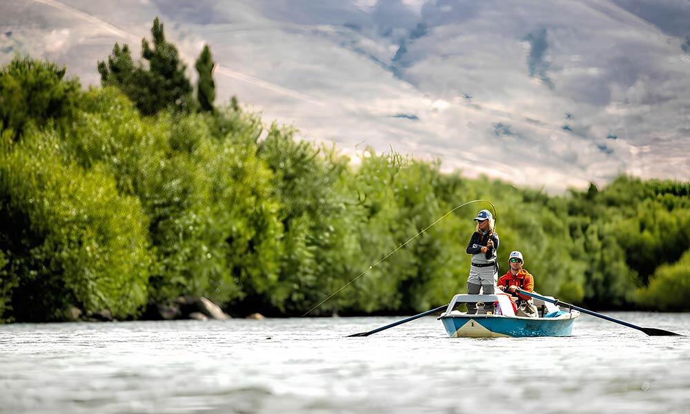 Guided fly fishing on river from boat, international fishing experiences