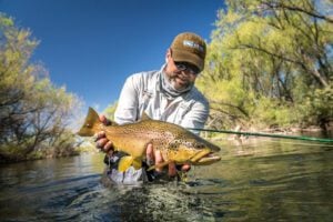 River brown trout held by angler