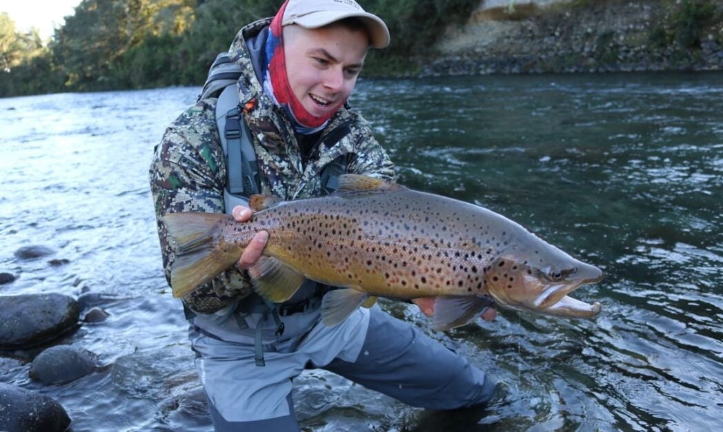 Angler holding trophy brown trout