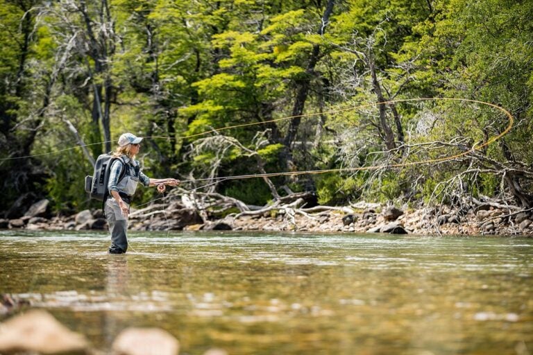 Woman casting for trout in river, Argentina