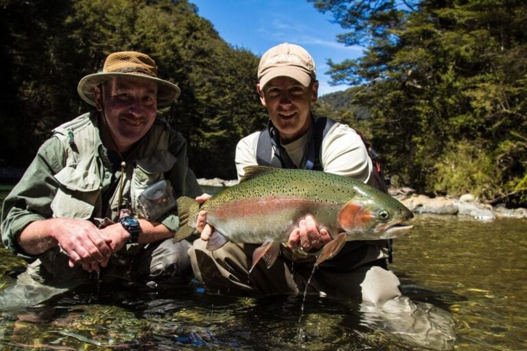 Angler holding rainbow trout - New Zealand fly fishing