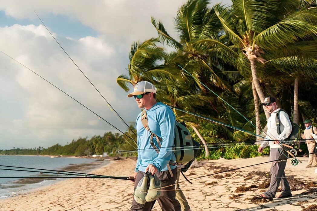 Fly fishermen in Mexico walking to skiffs