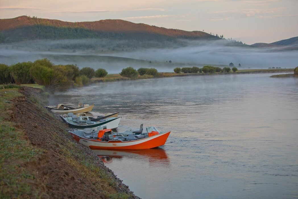 Skiff fishing boats on taimen river in Mongolia