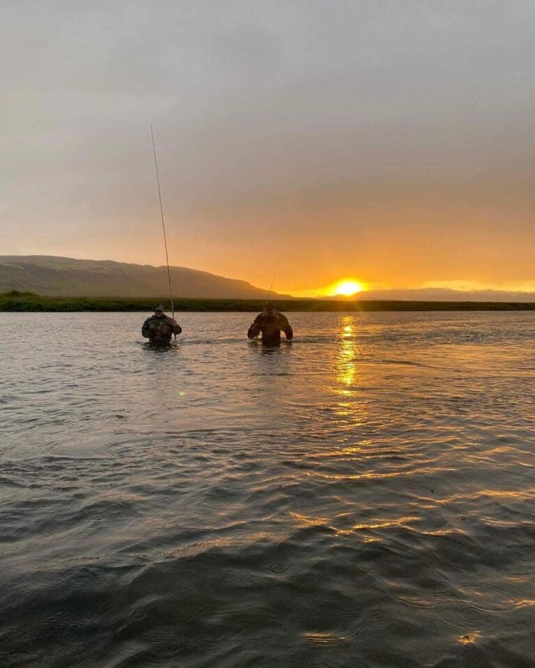 Anglers wading across Laxa river, Iceland