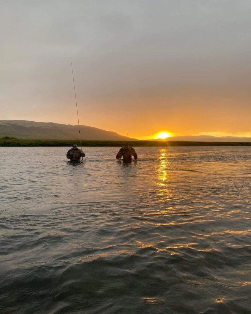 Anglers wading across Laxa river, Iceland