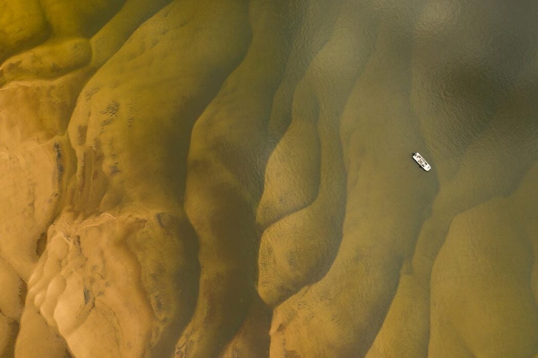 Clear golden dorado waters, drone shot