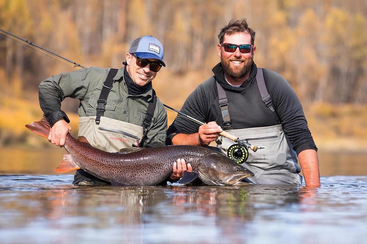 Large taimen held by guide - Mongolia