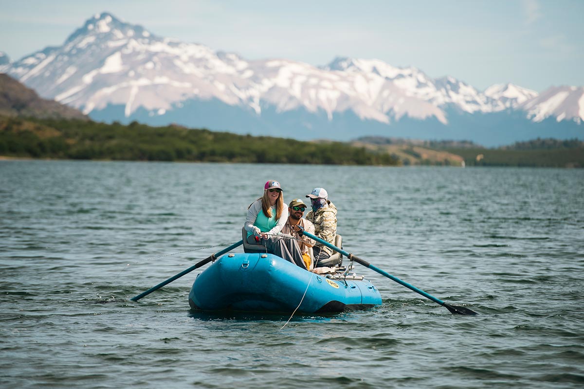 Anglers rowing raft on Patagonian lake