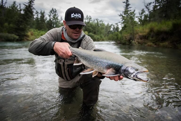 Angler holding Arctic char, Alaska