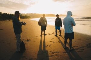 Fishing guests walking in sand during sunset in Colombia