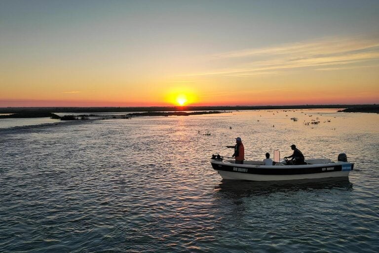 Anglers fishing for golden dorado from boat in Argentina