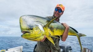 Large mahi-mahi held by angler game fishing in Colombia