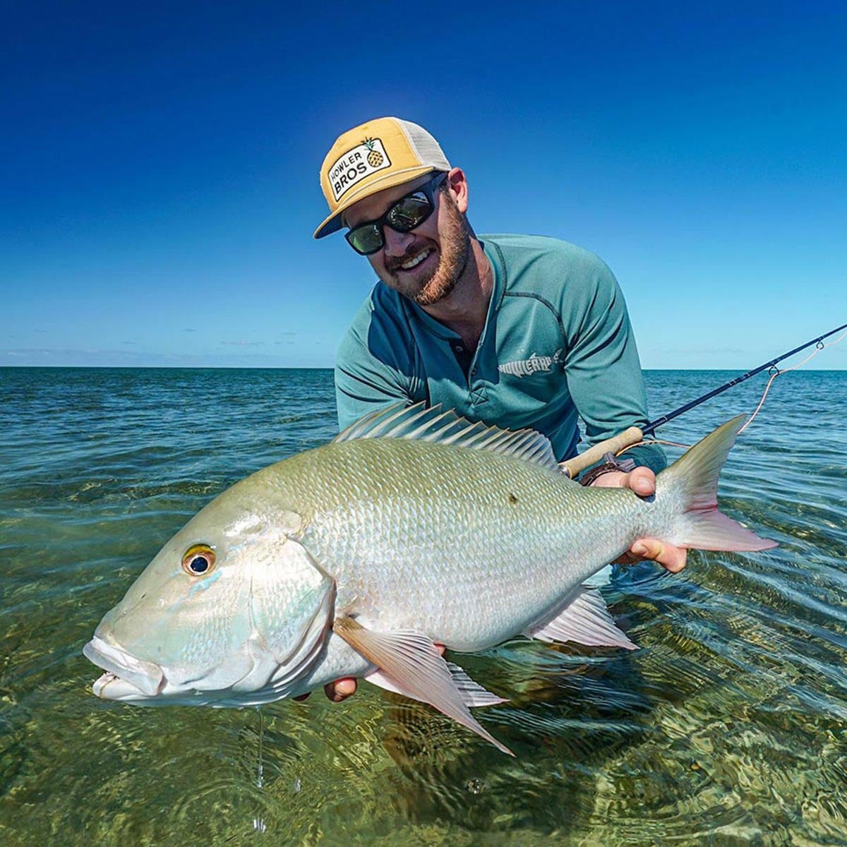 Fly fisherman holding snapper in Abaco, Bahamas