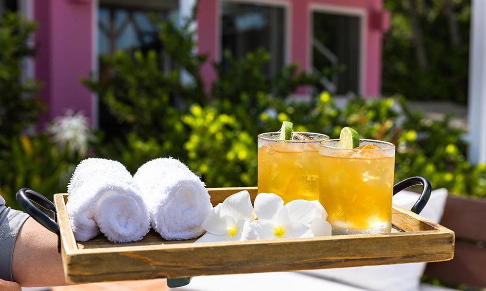 Tray with fresh drinks and cold face cloths
