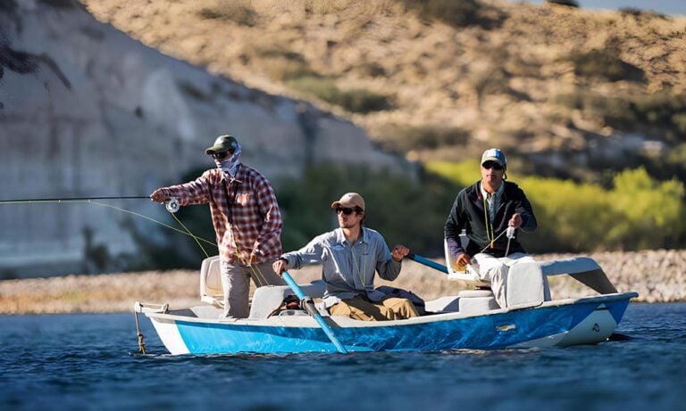 Anglers and guide in a drift boat in Patagonia casting for fish