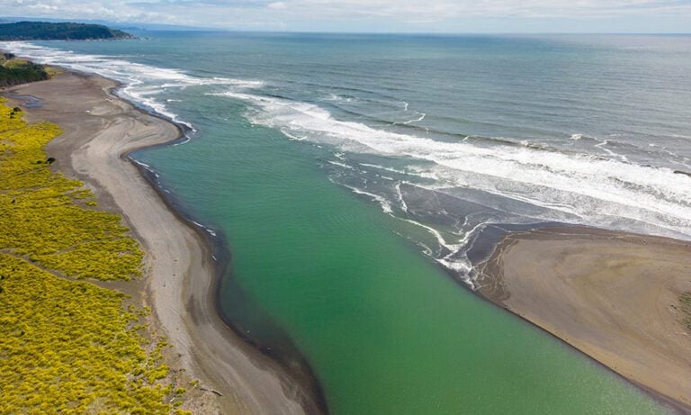 Overhead view of small river estuary running into the ocean