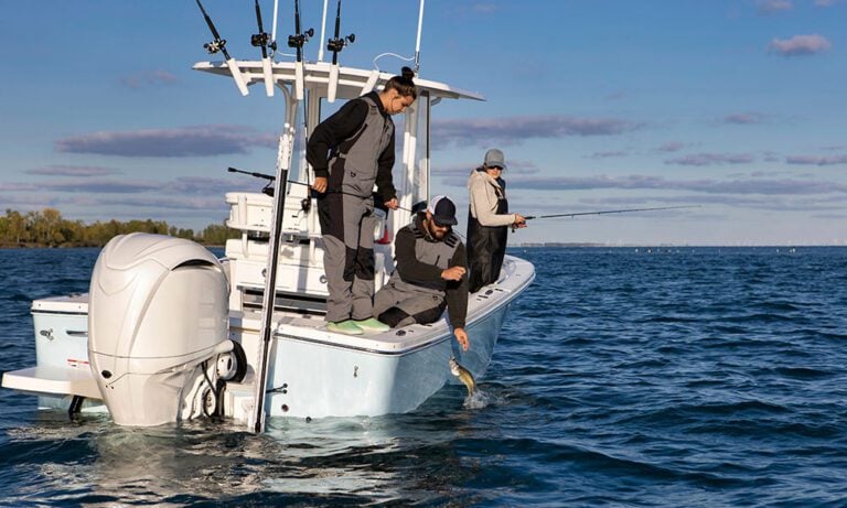 Anglers sea fishing from motor boat with large outboard engine