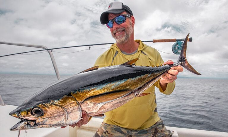 Tuna held by fly fisherman caught on the fly from a boat
