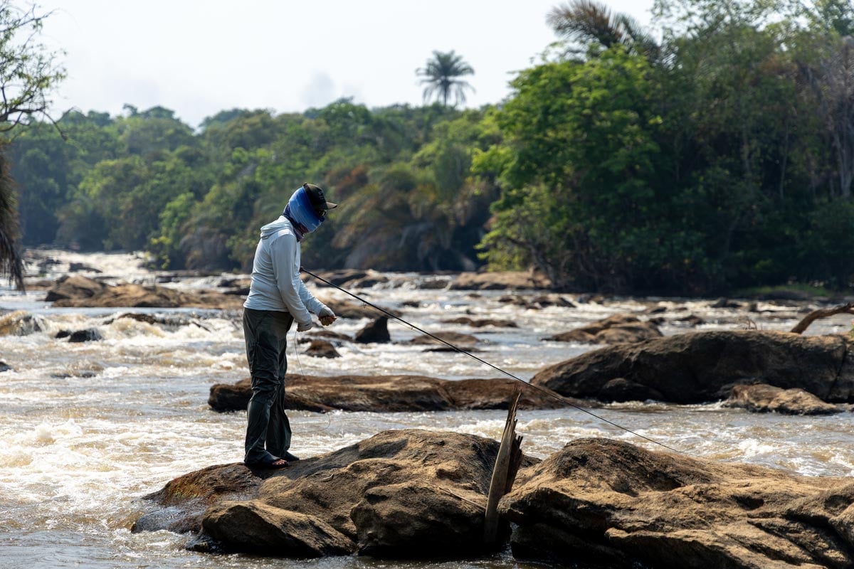 Angler fishing from rocks for tigerfish in Tanzania