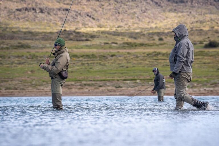 Guided fly fishing group wading Jurassic Lake at Estancia Laguna Verde, Patagonian trophy rainbow trout waters