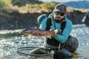 Fishing guide holding rainbow at Choy Choy Mallin
