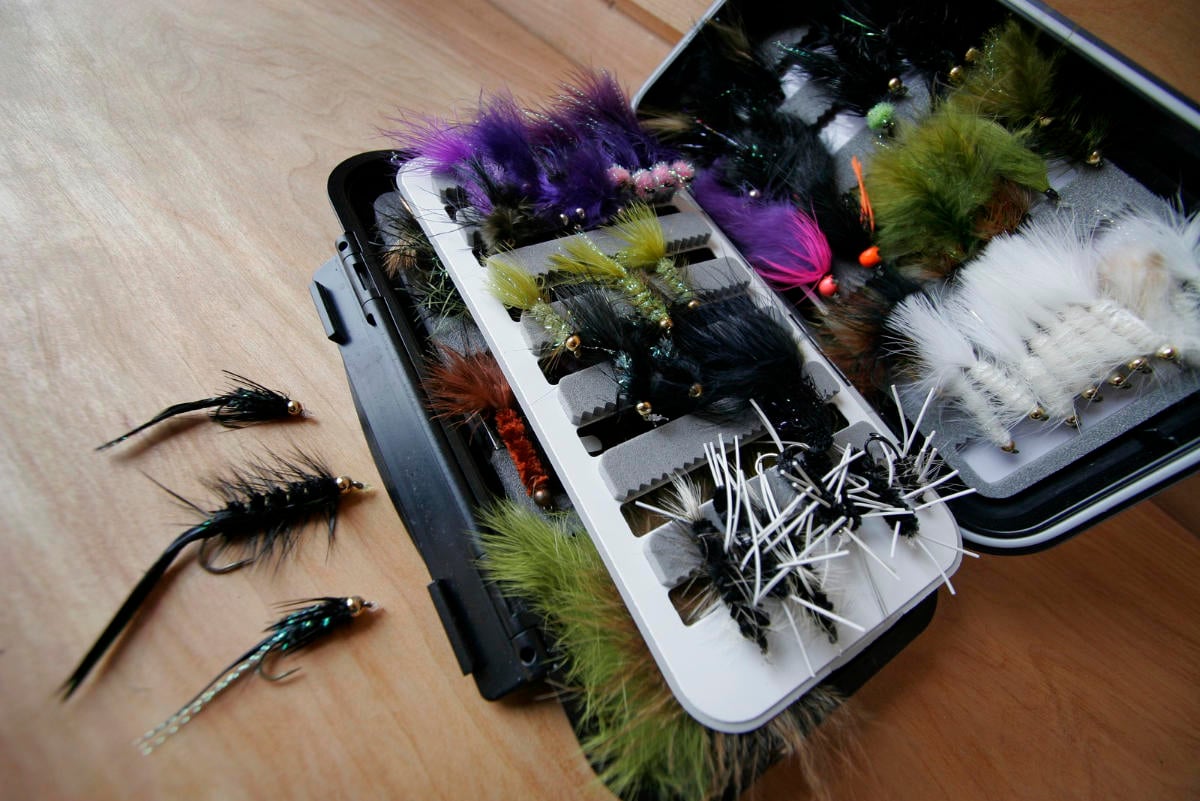 Open fly box with lures for Rio Grande sea-run brown trout in Tierra del Fuego
