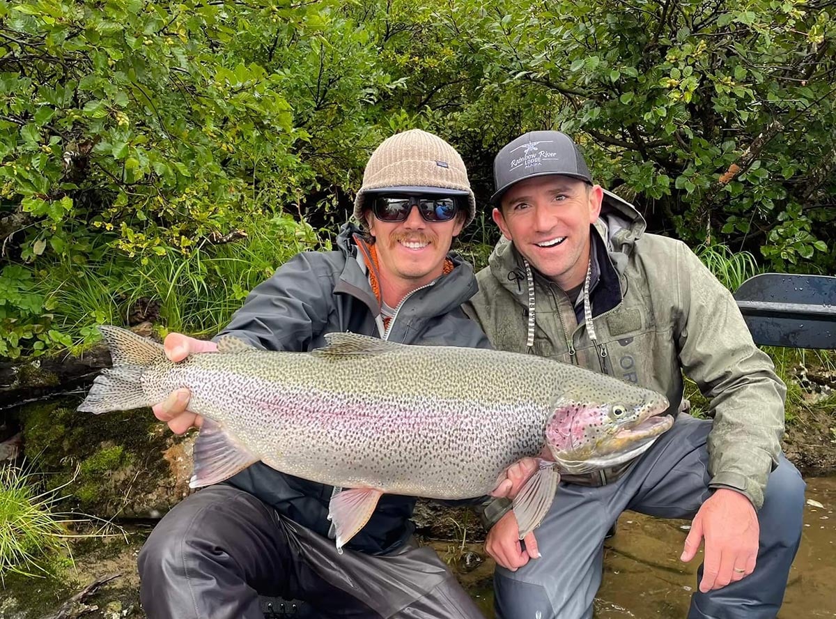 Trophy rainbow trout caught late season in Lake Iliamna region, Bristol Bay Alaska - held by two anglers 